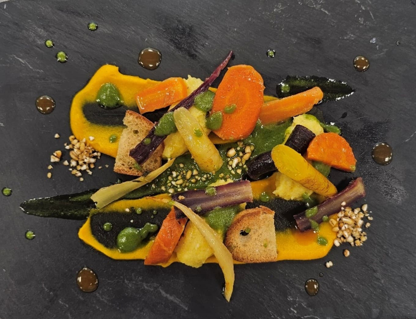Heritage Carrots with Polenta, carrot puree, toasted pearl barley, basil oil and vegan toasted bread.